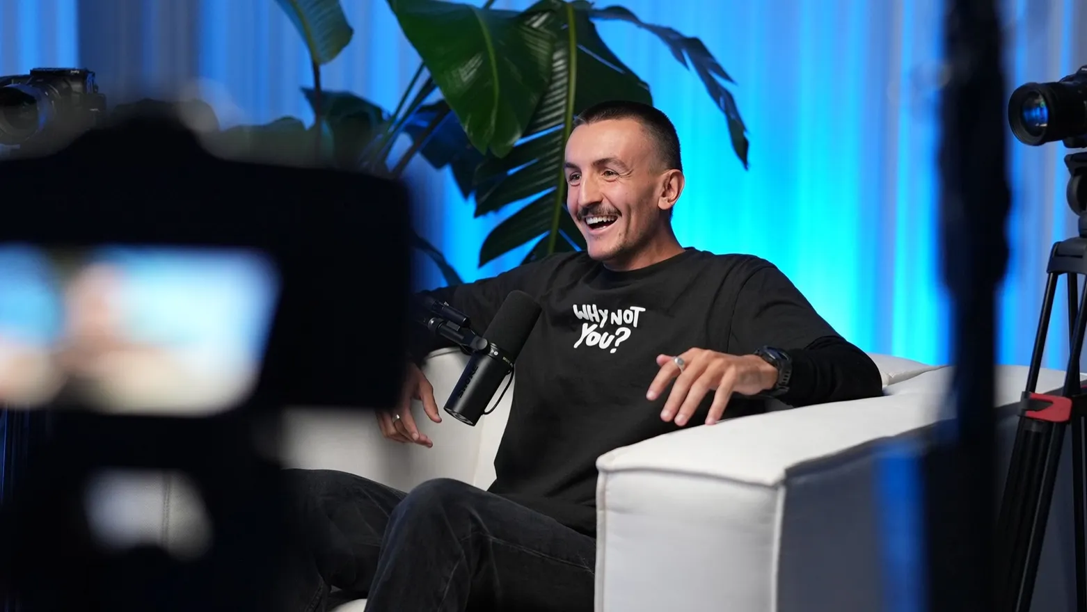 Wil laughing in the podcast chair